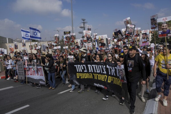 Family and supporters of the hostages held captive by Hamas in Gaza complete the final leg of a four-day march from the Israel-Gaza border to Jerusalem, to demand the immediate release of all hostages, near Jerusalem, Saturday, March 2, 2024. The hostages, mostly Israeli citizens, were abducted during the brutal Oct. 7 Hamas cross-border attack in Israel and have been held in the enclave since as war rages. (AP Photo/Mahmoud Illean)